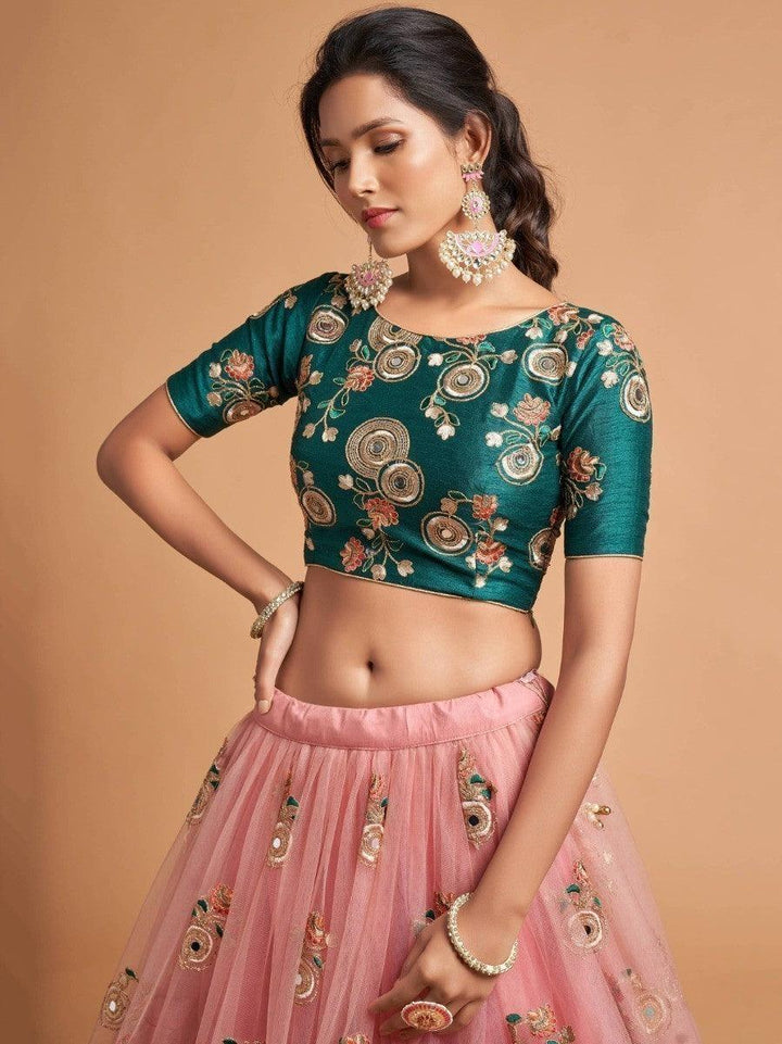 Designer peach lehenga with matching dupatta and choli.