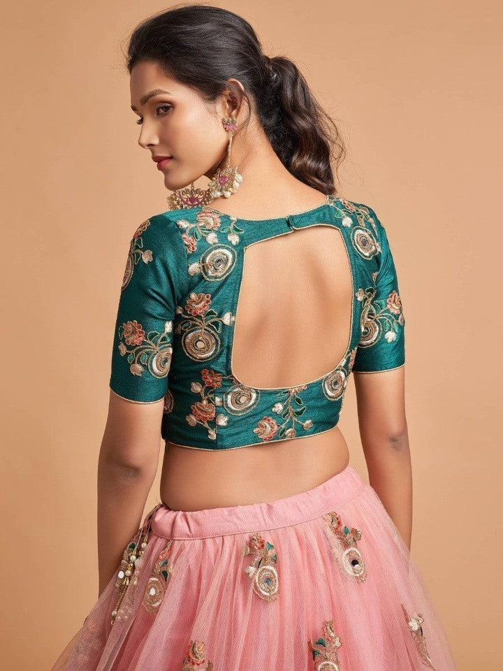 Peach lehenga with intricate zari and thread embroidery.