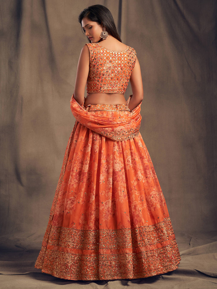 Semi-stitched orange crop top lehenga with floral details