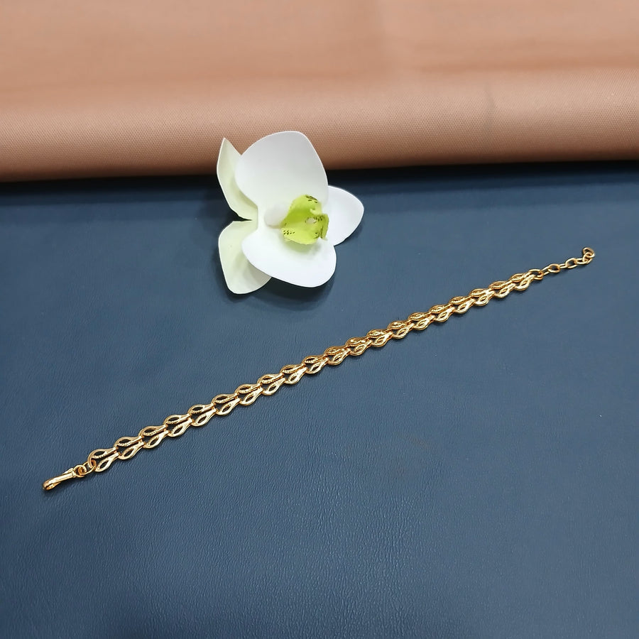 Sophisticated golden bracelet with gemstone details, ideal for formal events.