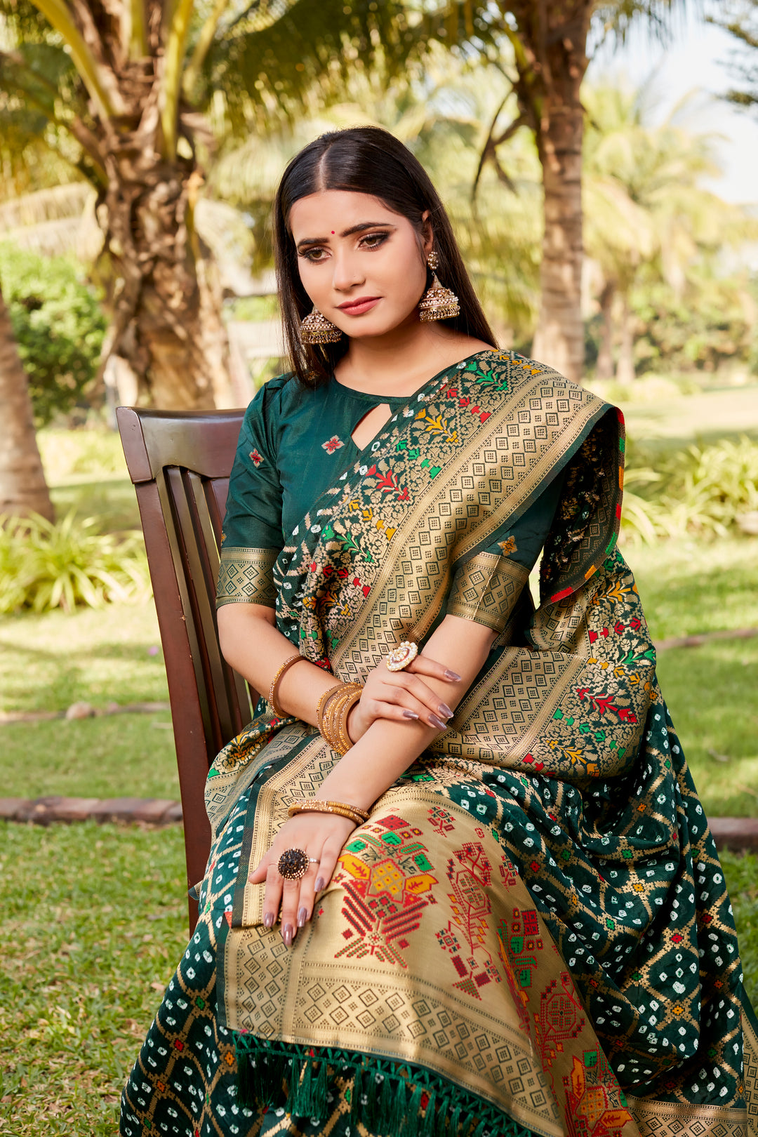 Elegant hot pink Gharchola Bandhej silk saree with a beautifully woven meenakari border, ideal for weddings and cultural celebrations.