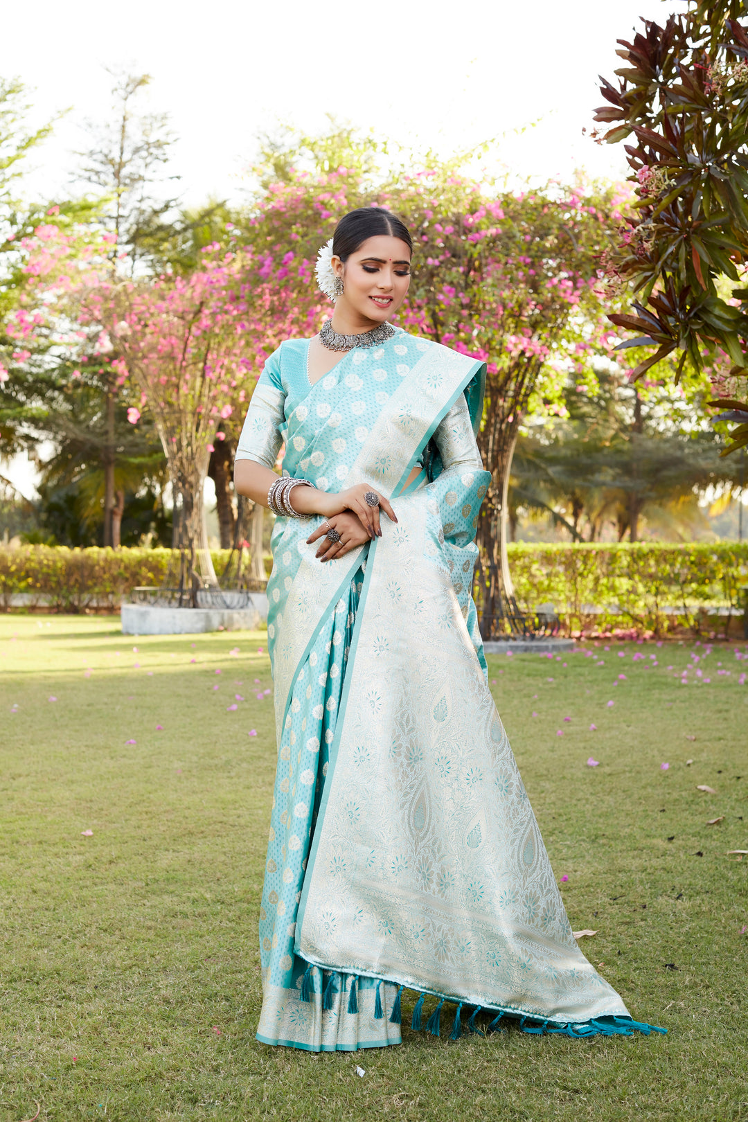 Green Kanjivaram saree with detailed butta weaving, a rich woven pallu, and a shimmering satin finish for elegance.