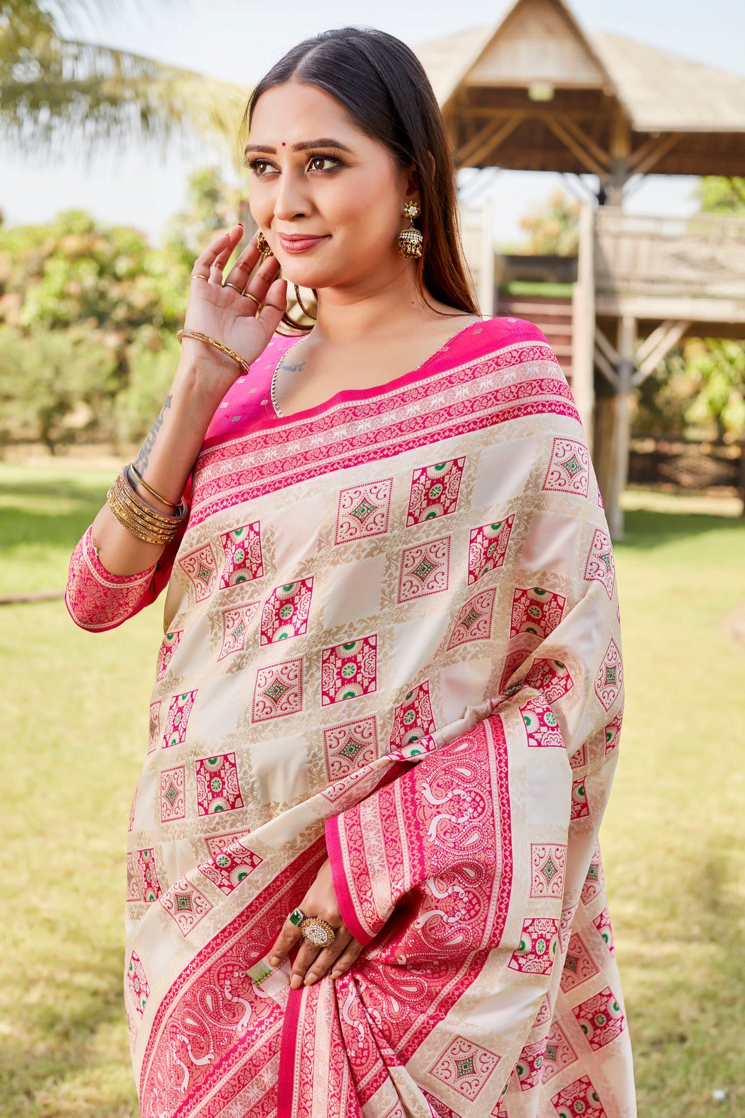 Pink Kanjivaram soft silk saree with elegant designer borders and intricate traditional motifs.