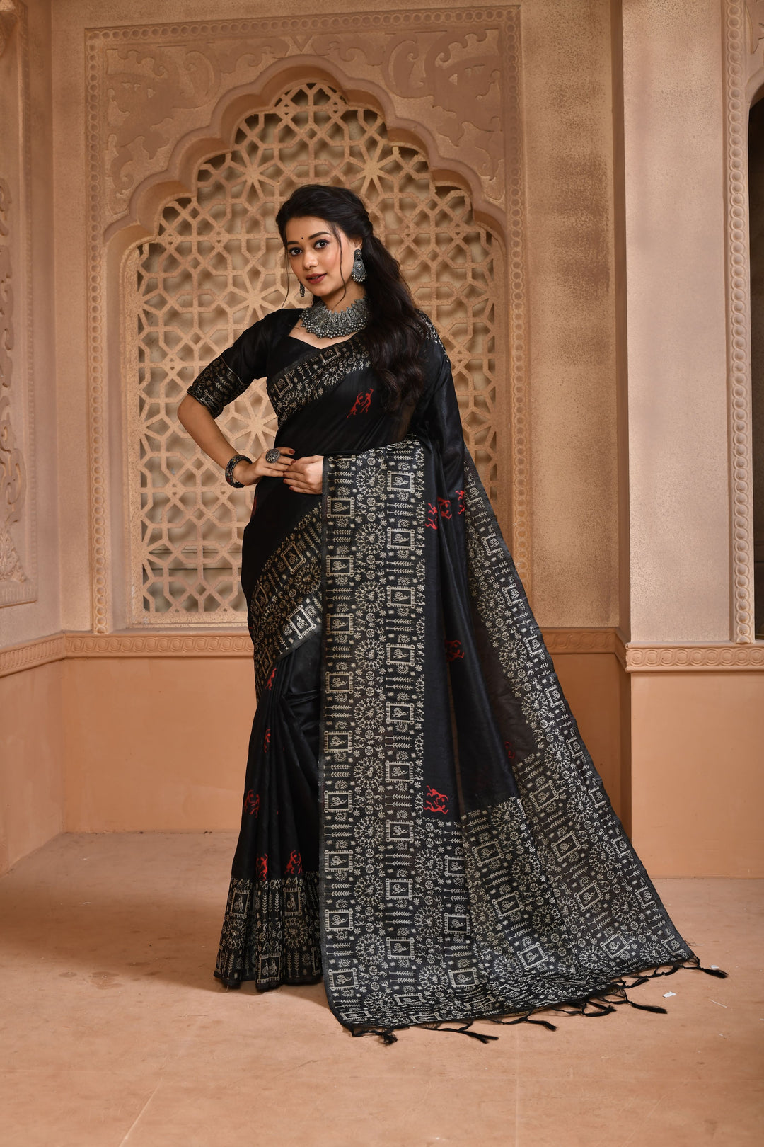 Stunning black handloom raw silk saree with intricate pallu weaving, ideal for traditional celebrations.