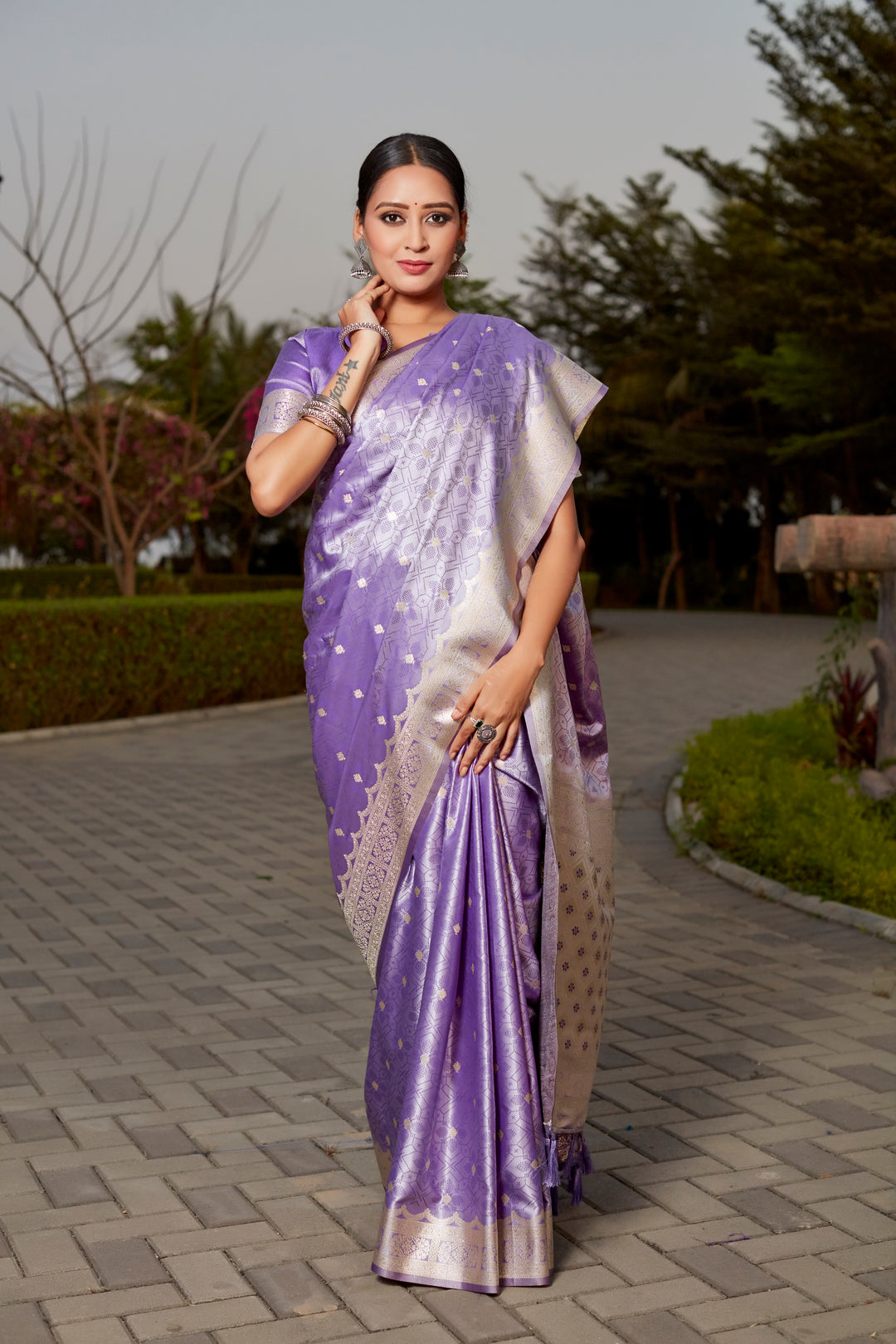 Stunning purple Kanjivaram silk saree with intricate butta work and designer border, perfect for bridal wear.