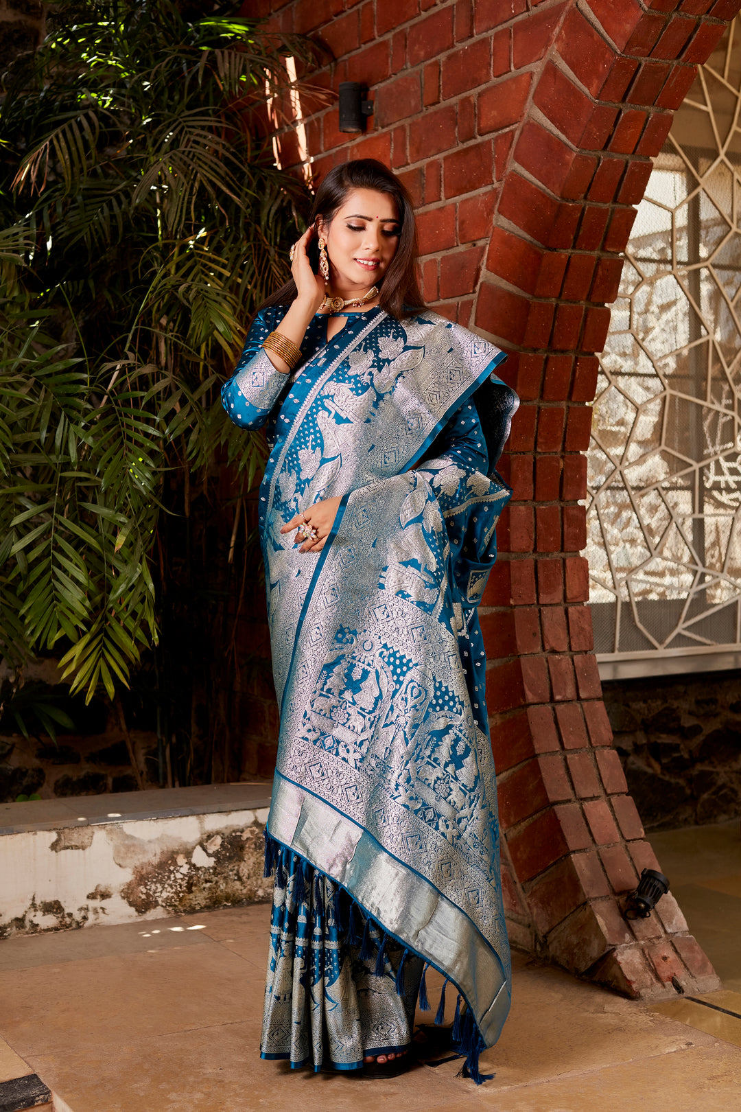 Timeless blue Kanjivaram satin saree with shimmering fabric and finely woven pallu, ideal for making a grand entrance at special events.