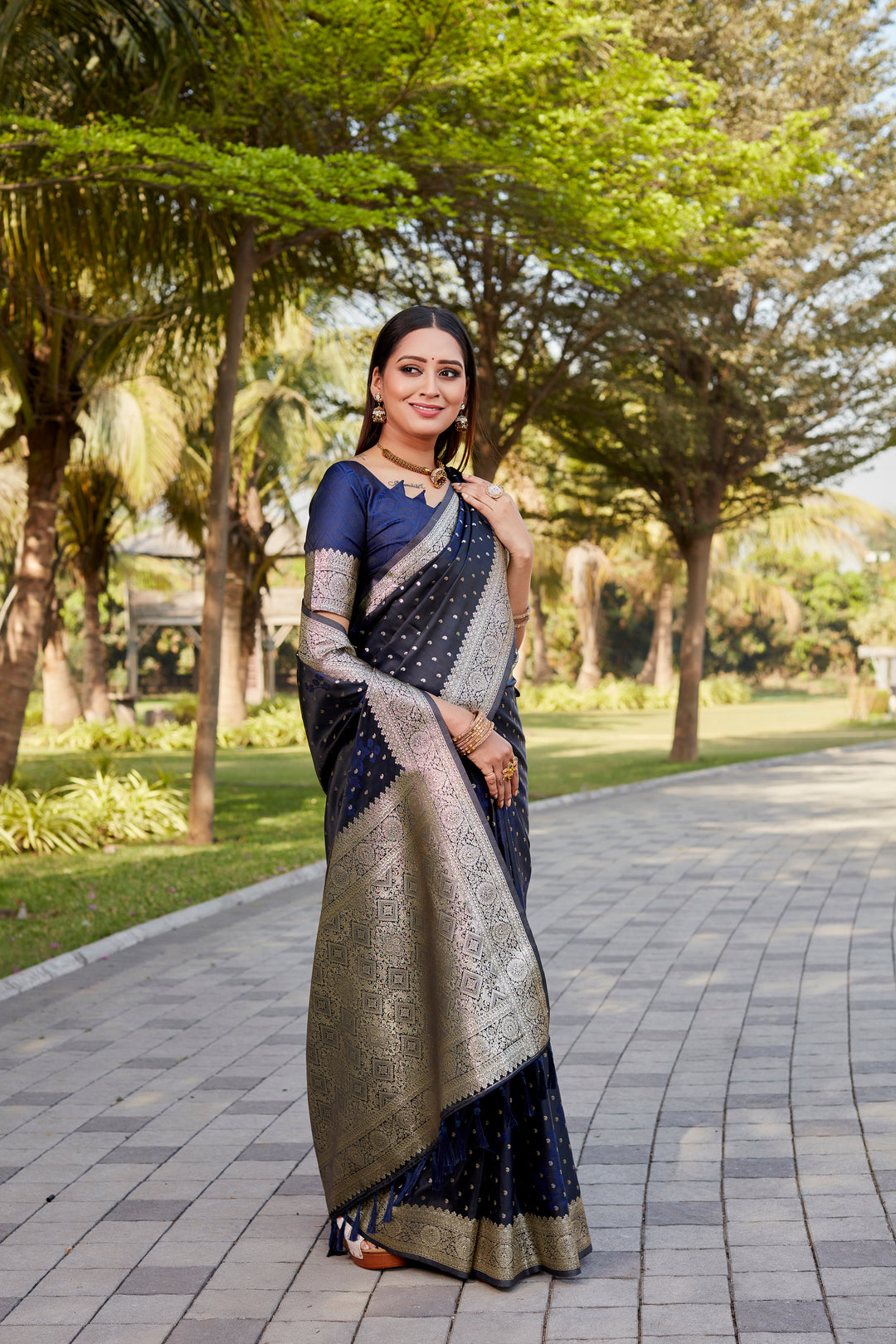 Luxurious navy Soft Satin Kanjivaram saree with intricate butta work and a lustrous finish.