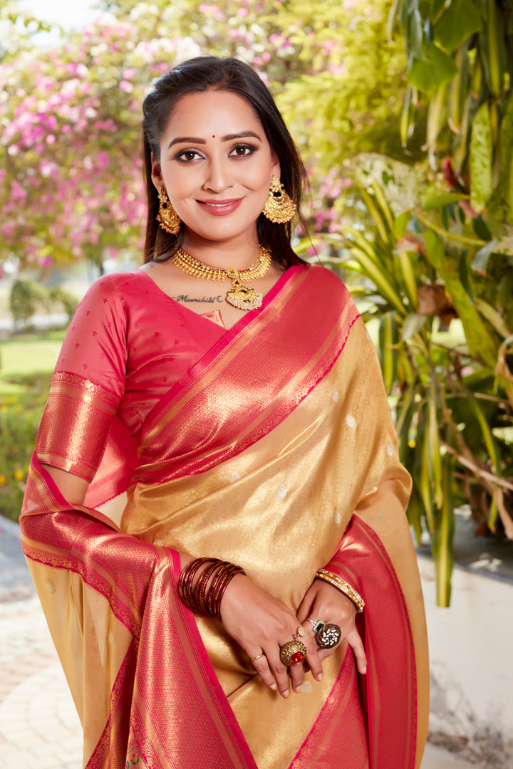 Classic beige tissue silk saree with rich pallu and contrast blouse, ideal for weddings and celebrations.