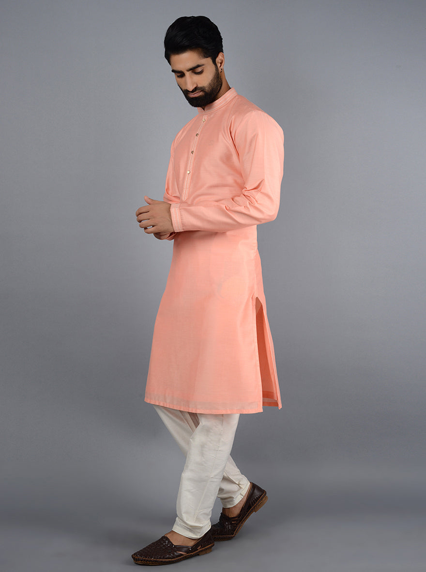 Stylish peach kurta featuring intricate embroidery for celebrations.