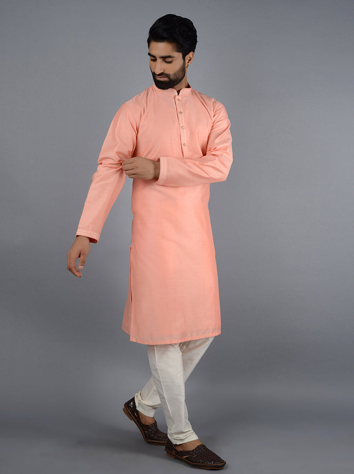 Elegant peach kurta set perfect for festive gatherings.