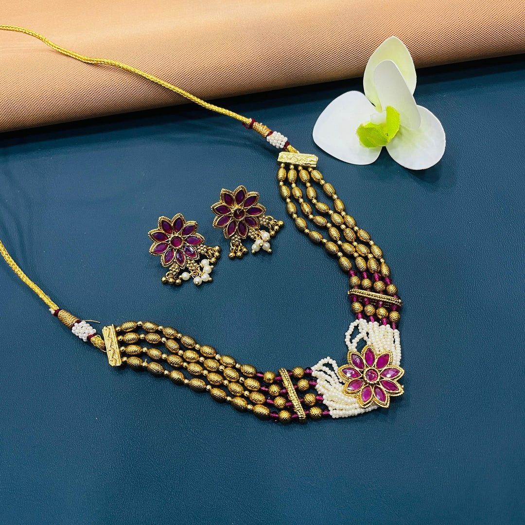 Classic Indian choker necklace in antique gold, crafted in metal for a timeless look at festivals.