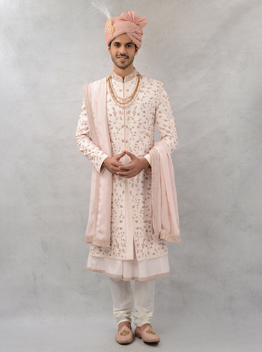 Celebrate love in style with this beautifully crafted fawn pink silk blend sherwani, featuring detailed embroidery for a refined look.