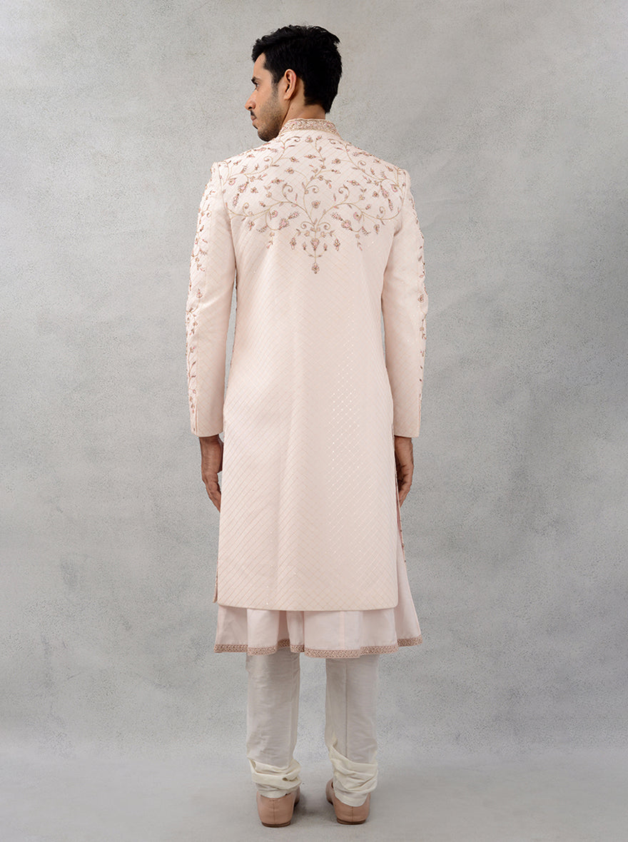 Make a stunning impression at weddings with this fawn pink silk blend sherwani, showcasing exquisite embroidery for a perfect blend of tradition and modernity.