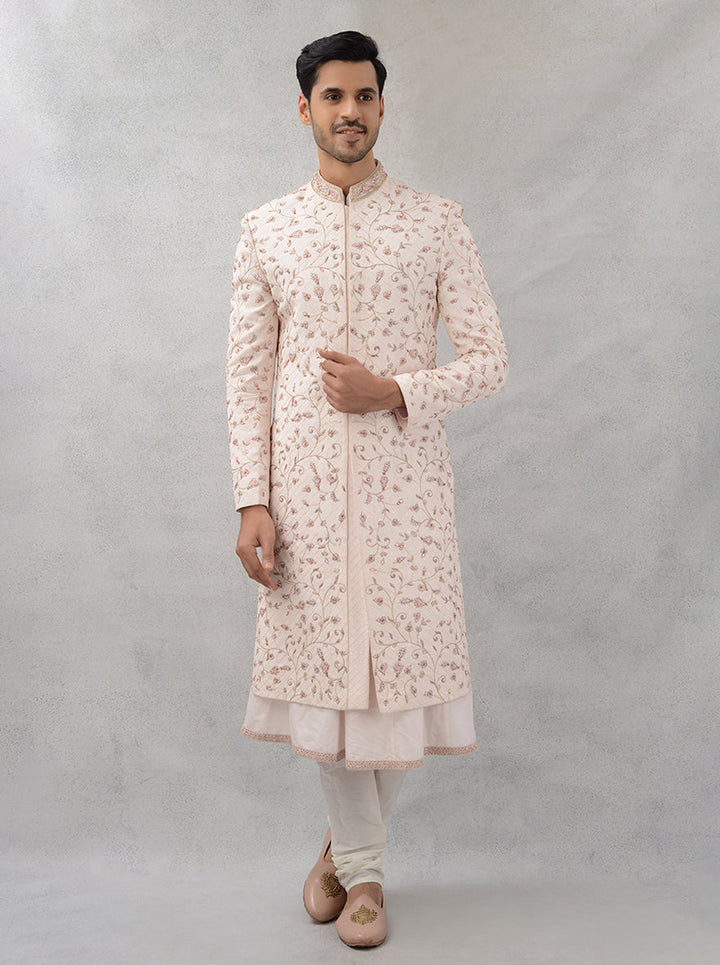 Elevate your wedding wardrobe with this fawn pink silk blend sherwani, featuring intricate embroidery that ensures you shine on your special day.