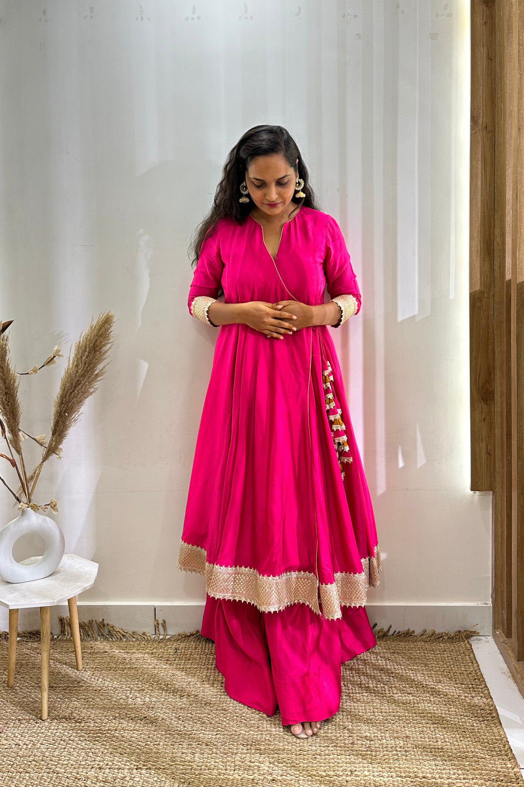 Vibrant hot pink Anarkali in Angrakha silhouette with a stylish contrast tissue dupatta for festive celebrations.