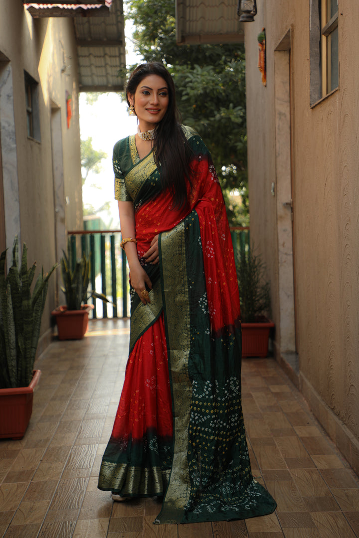 Traditional Bandhej Tapeta saree in vibrant red, perfect for weddings and celebrations.