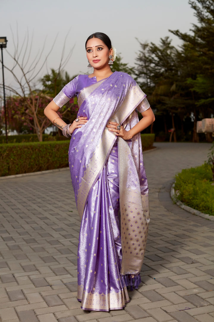 Elegant purple Kanjivaram silk saree with intricate butta work and designer border, ideal for festive events.