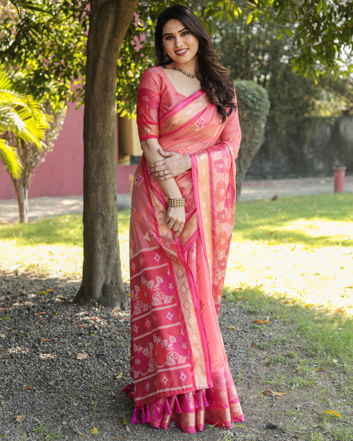 Soft pink Organza Ikkat weave saree with matching pallu and tassels, perfect for casual gatherings.