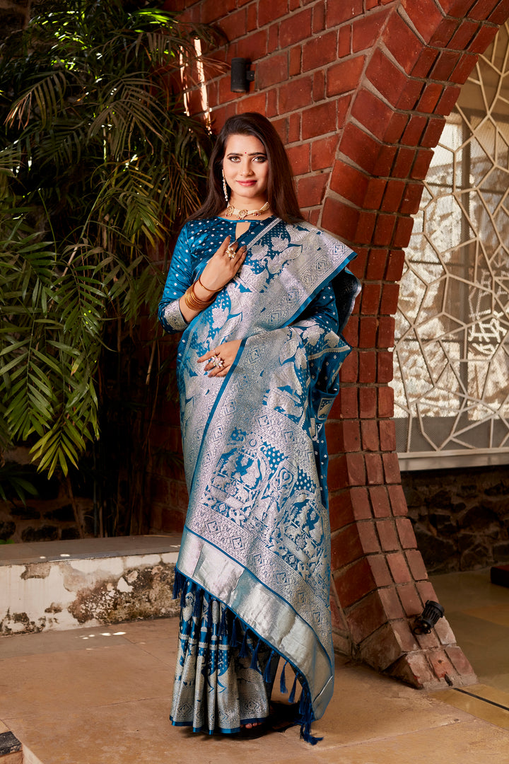 Beautiful blue Kanjivaram silk saree with delicate butta work and a matching woven pallu, perfect for adding grace to festive occasions.