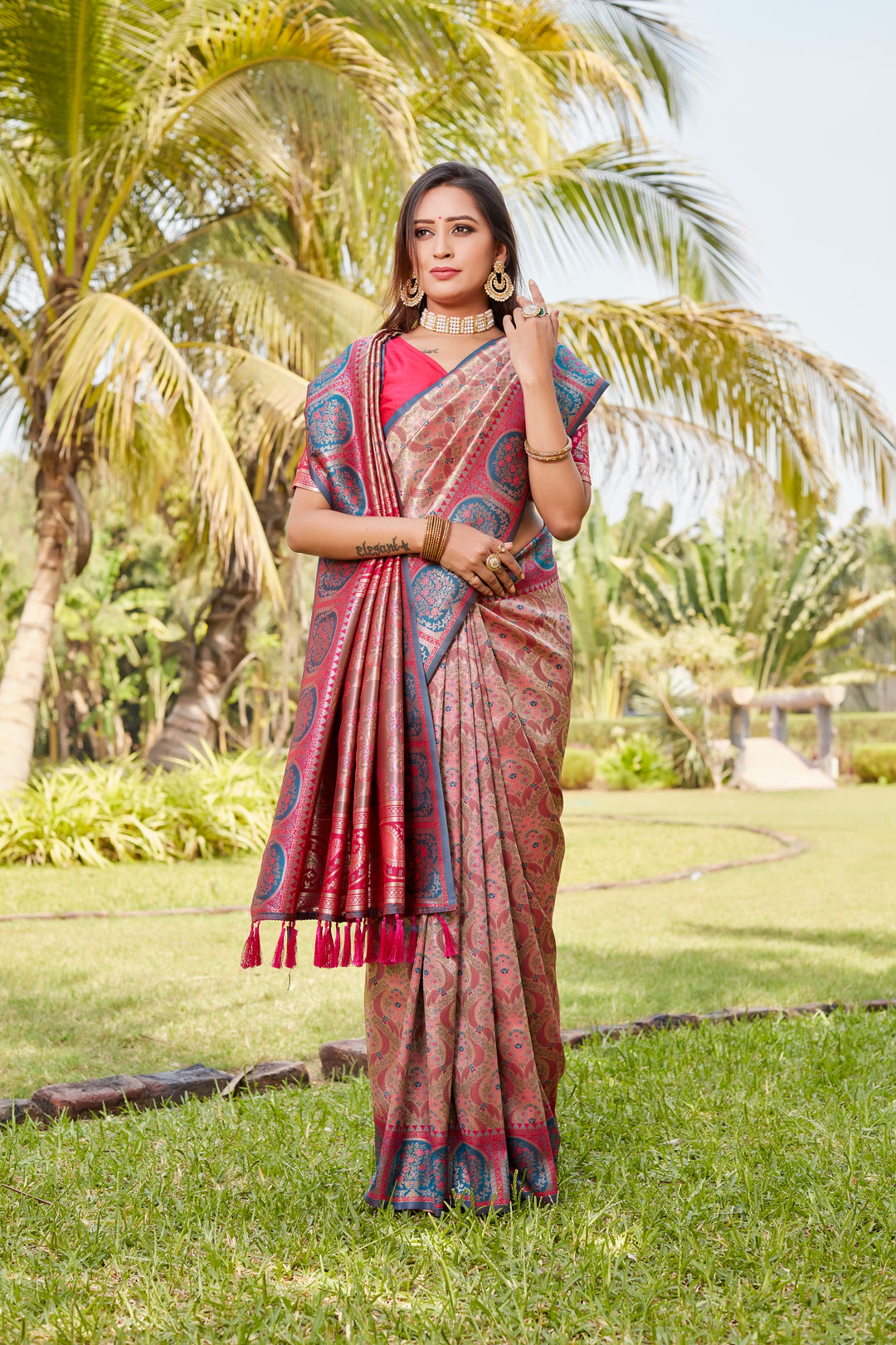 Timeless coral-pink Kanjivaram soft silk saree with intricate work and rich pallu for special events.