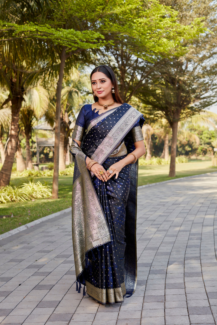 Navy Satin Kanjivaram saree with delicate butta design and shimmering satin sheen.