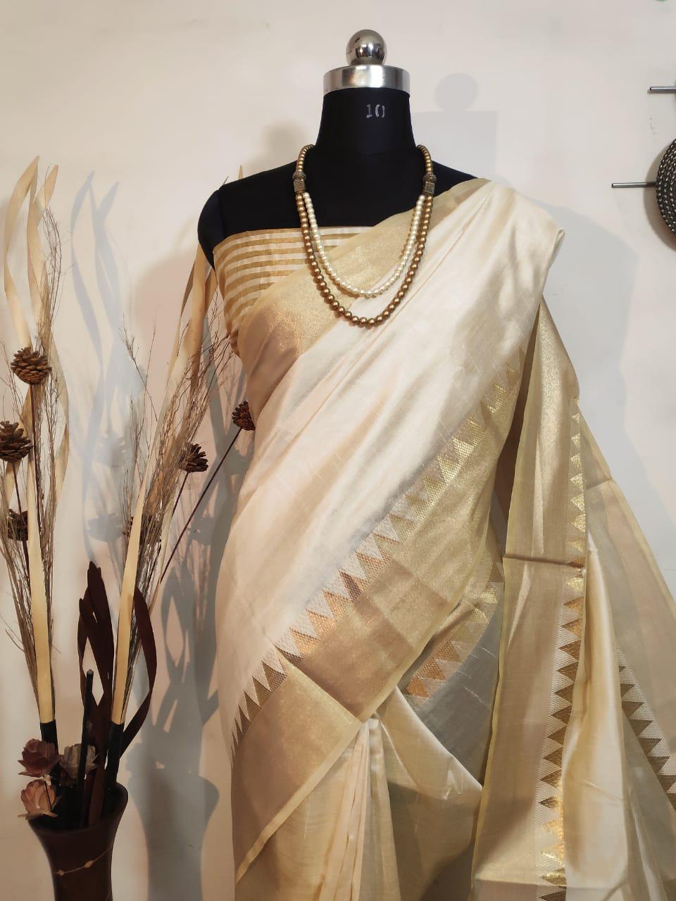 Stunning cream Indian wedding saree with a classic zari border, pallu, and matching blouse, ideal for cultural events.