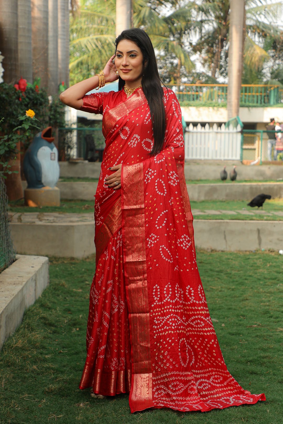 Vibrant red Bandhej silk saree with a stunning jari weaving border and Bandhej pallu, ideal for cultural events.