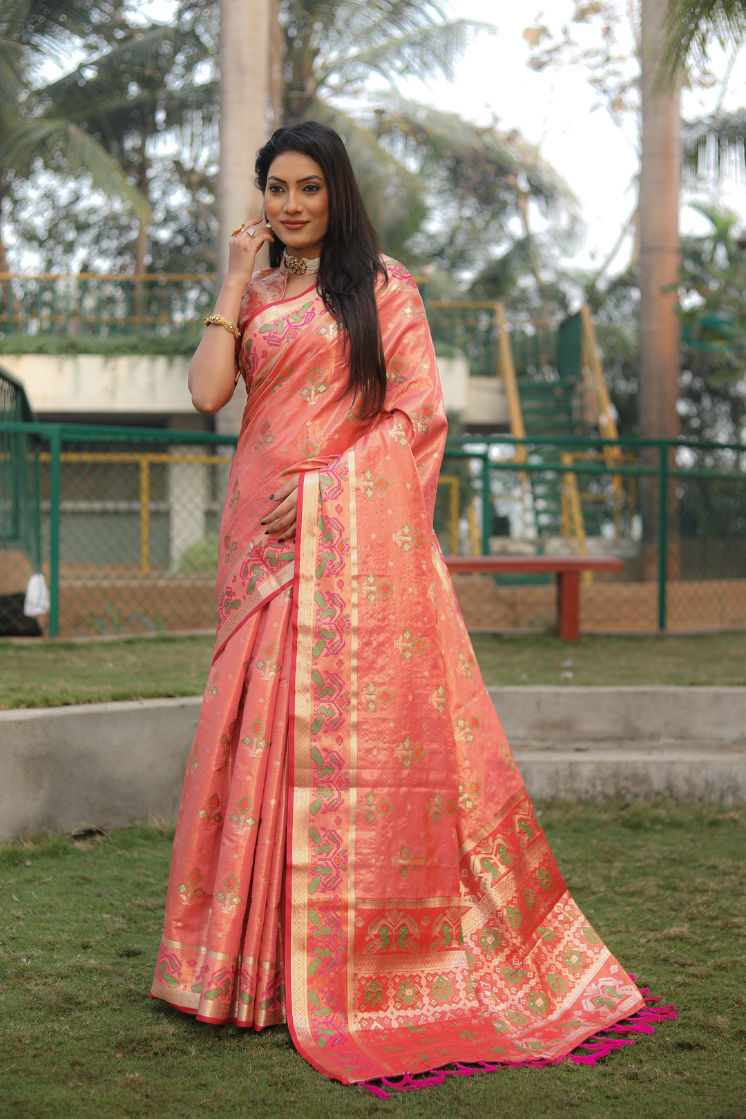 Chic olive organza saree with vibrant Ikkat Patola design, perfect for a festive look.