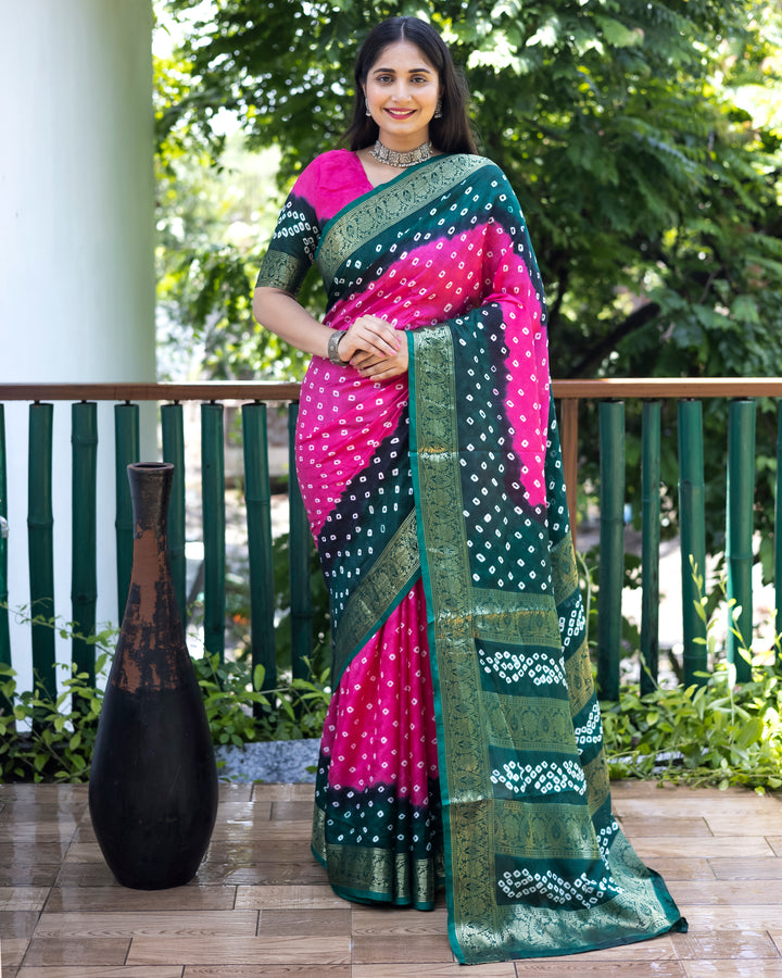 Stunning pink Bandhej silk saree with detailed zari work and matching blouse, perfect for traditional events.