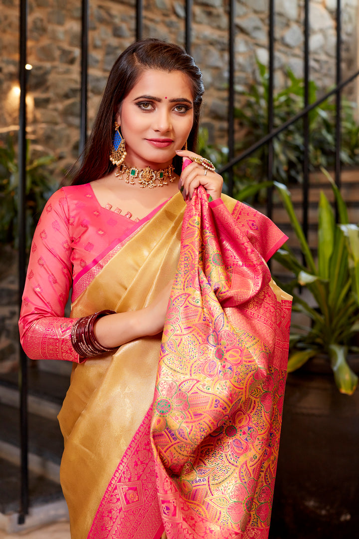 Light-peach Tissue silk saree with stunning contrast border and intricate weaving details.