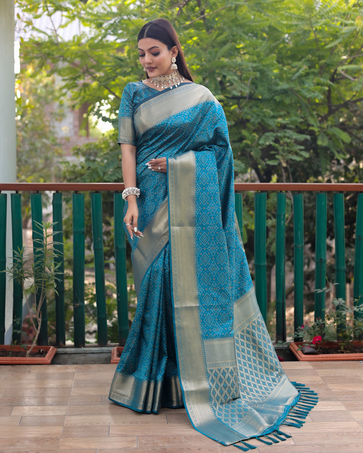 Stunning blue Patola silk saree featuring a combination of Bandhej patterns and contrast zari borders, exuding sophistication.