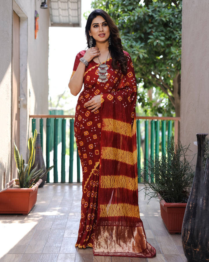 Rich maroon Bandhej silk saree with exquisite zari weaving and Sibory motifs, perfect for weddings and celebrations.