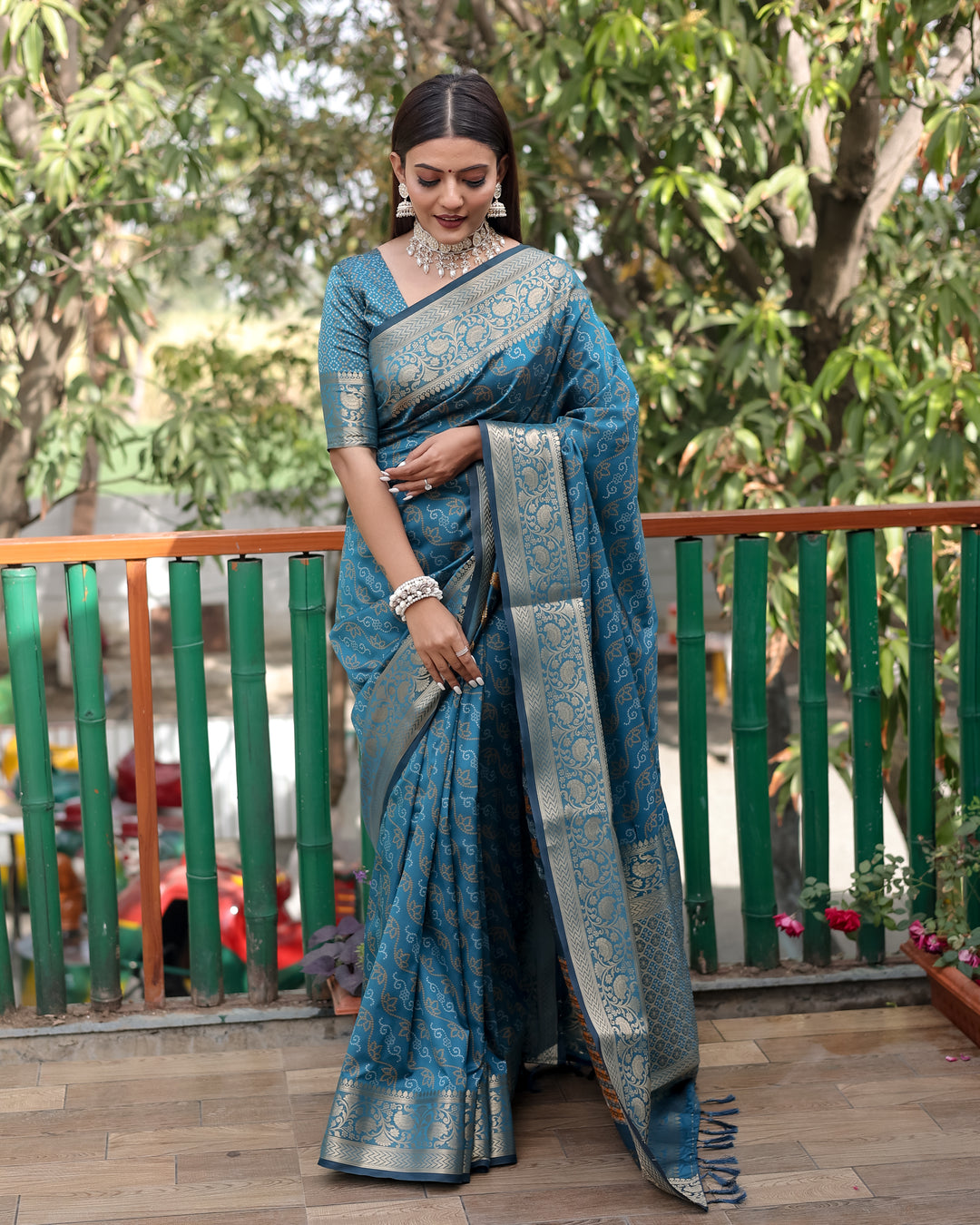 Regal maroon Bandhej Patola silk saree with intricate zari work and Kanchi borders, ideal for traditional ceremonies.