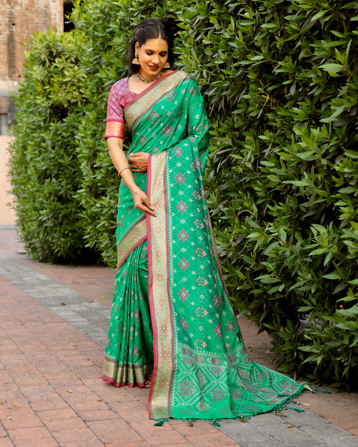 This mint green Ikkat Patola silk saree boasts intricate designs and a rich Zari border, perfect for any grand celebration.