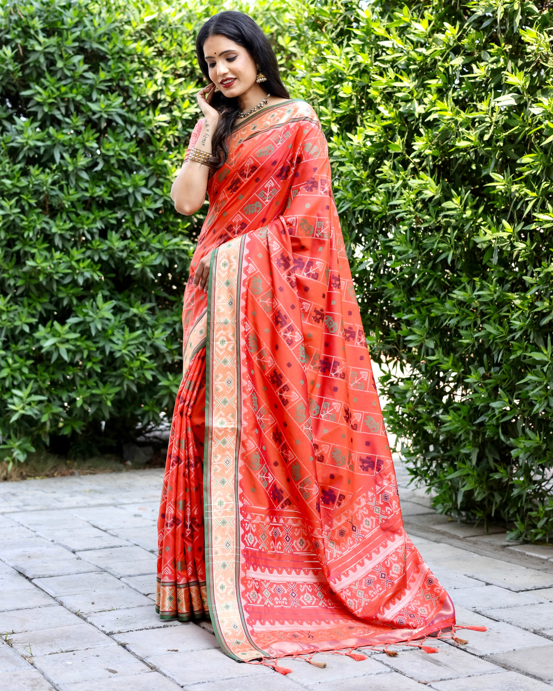 Beautiful orange Bandhej silk saree with intricate zari woven pallu and matching blouse, perfect for festive occasions.