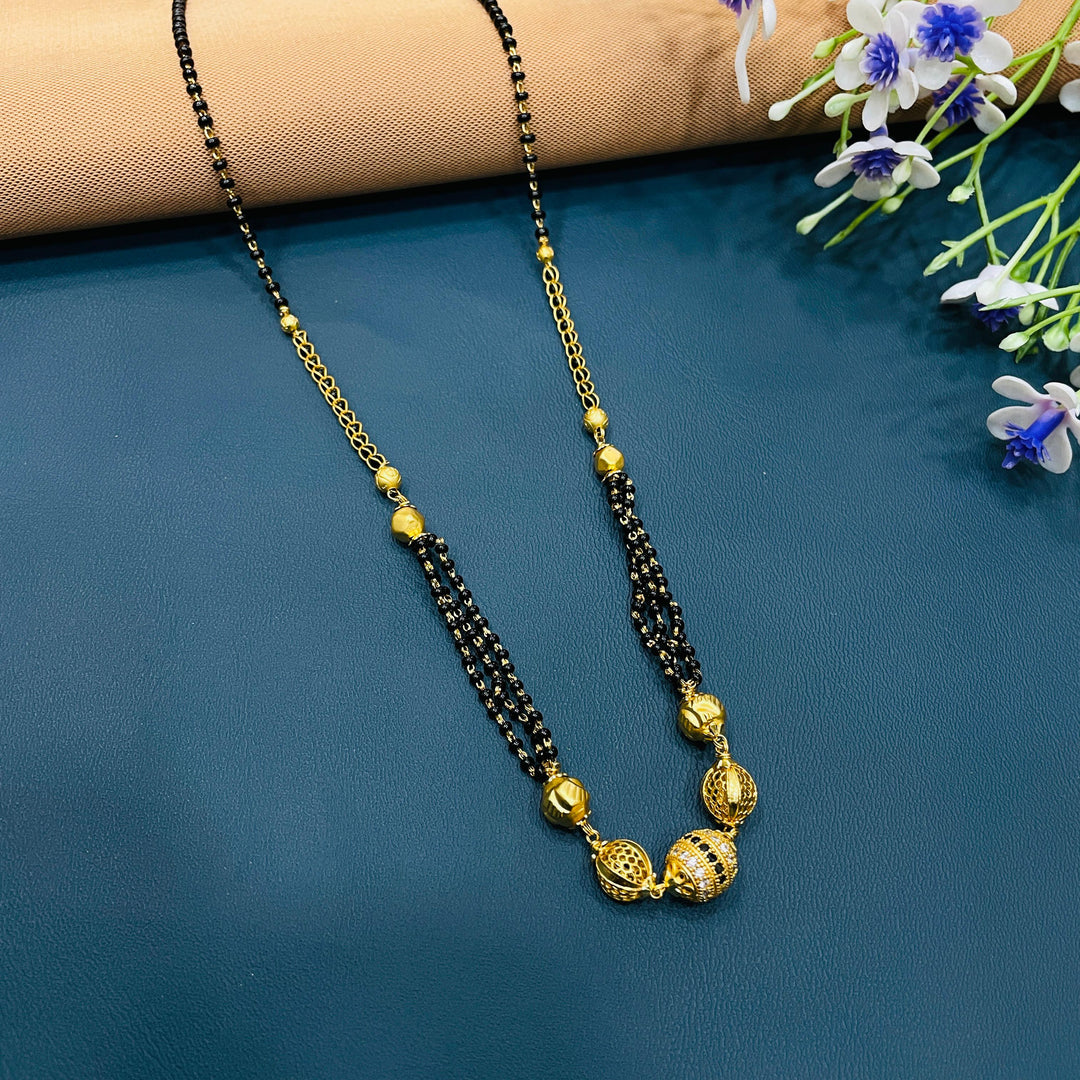 Elegant black beaded mangalsutra in alloy, traditional gold-plated necklace for women.