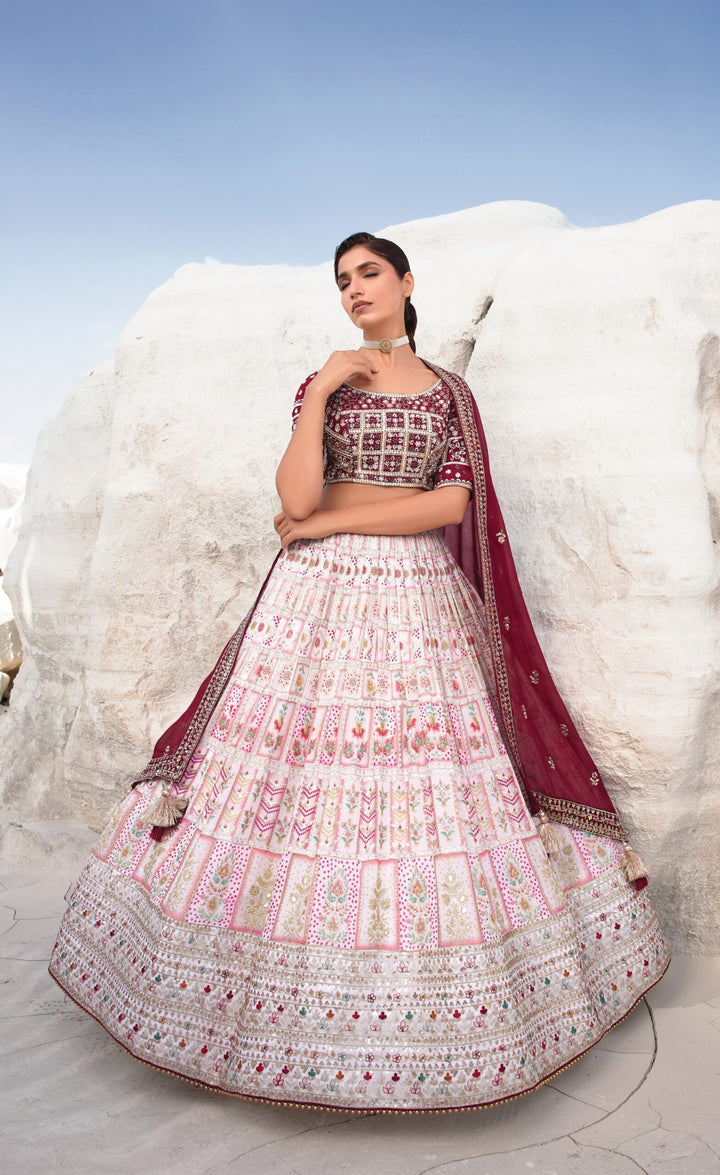 Chic maroon and pink lehenga, a handcrafted embroidery masterpiece designed for brides wanting a unique wedding outfit.