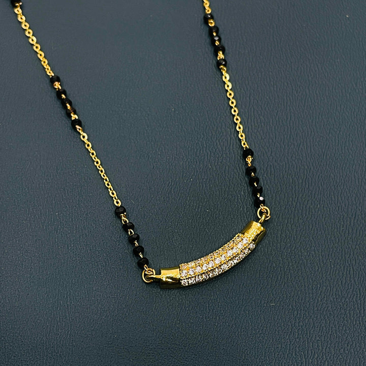 Elegant gold-plated black beaded mangalsutra necklace, crafted from durable alloy.