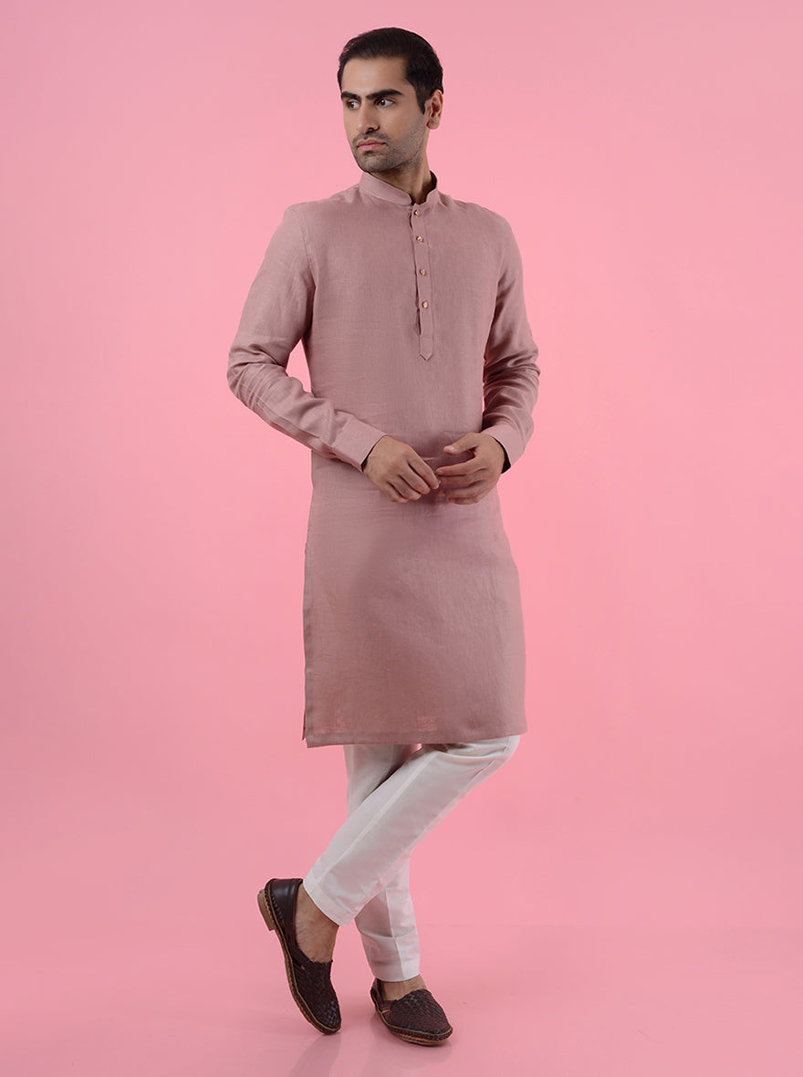 Comfortable onion pink kurta pajama for men, made from linen for relaxed ethnic style.