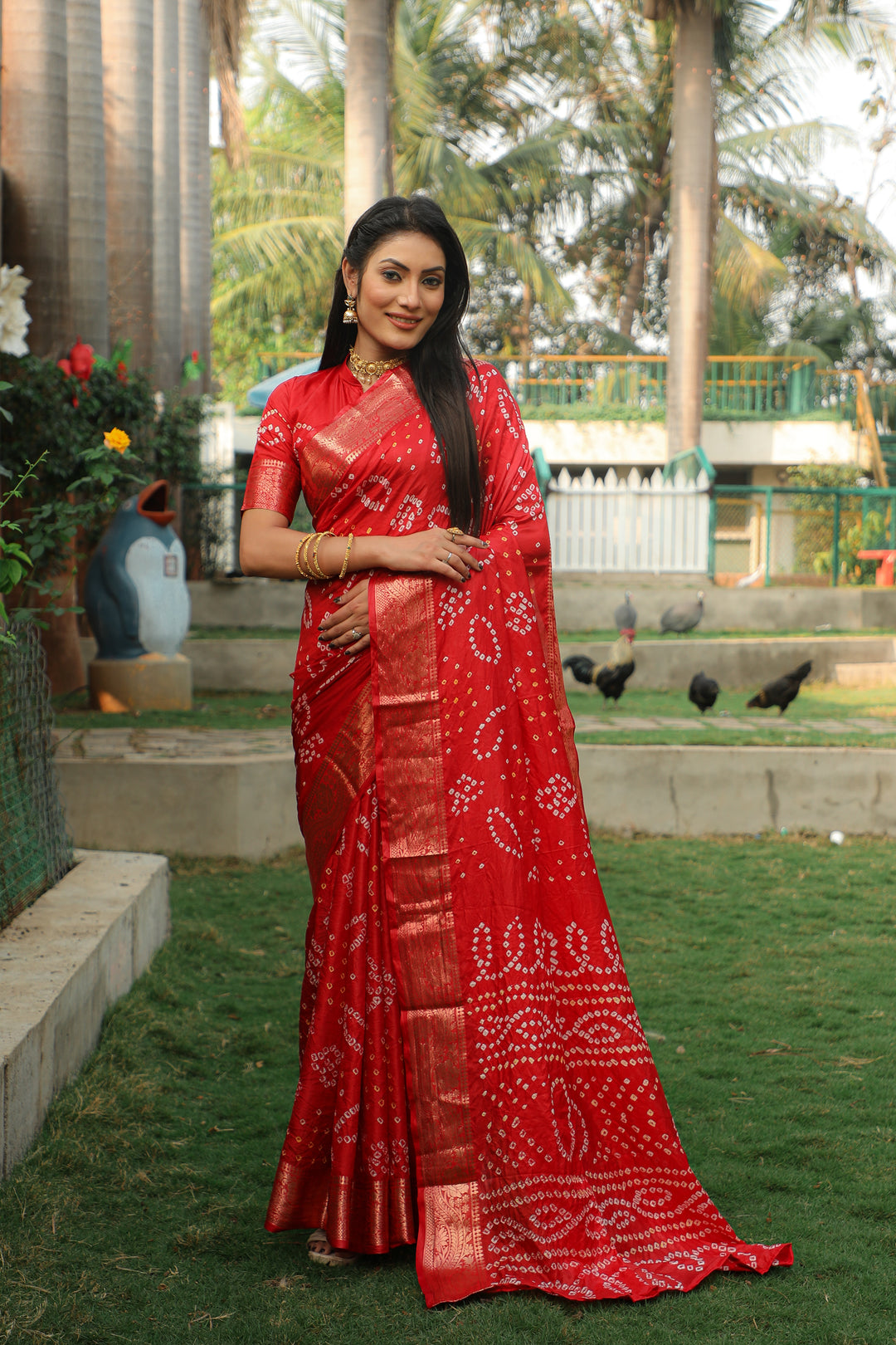 Gorgeous red Bandhej silk saree featuring jari weaving and a rich Bandhej pallu, designed for grand occasions.