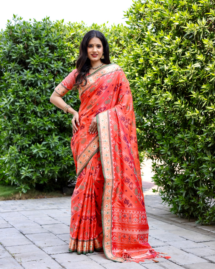 Elegant orange Bandhej silk saree with matching blouse and zari woven pallu, perfect for grand celebrations.