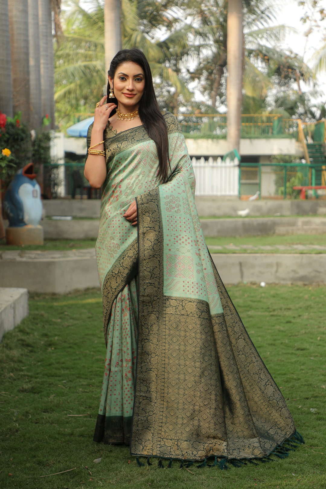 Green Kanjivaram silk saree with intricate detailing and rich colors, perfect for cultural events.