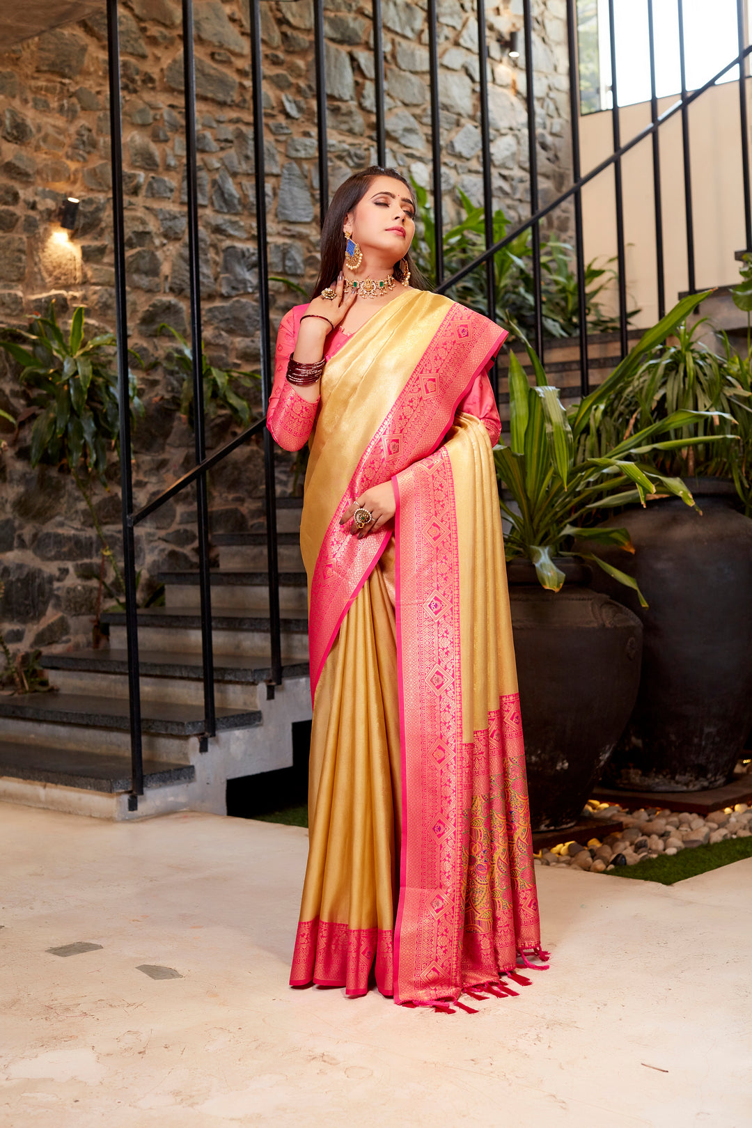 Classic light-peach Tissue silk saree with intricate weaving and vibrant contrast border.