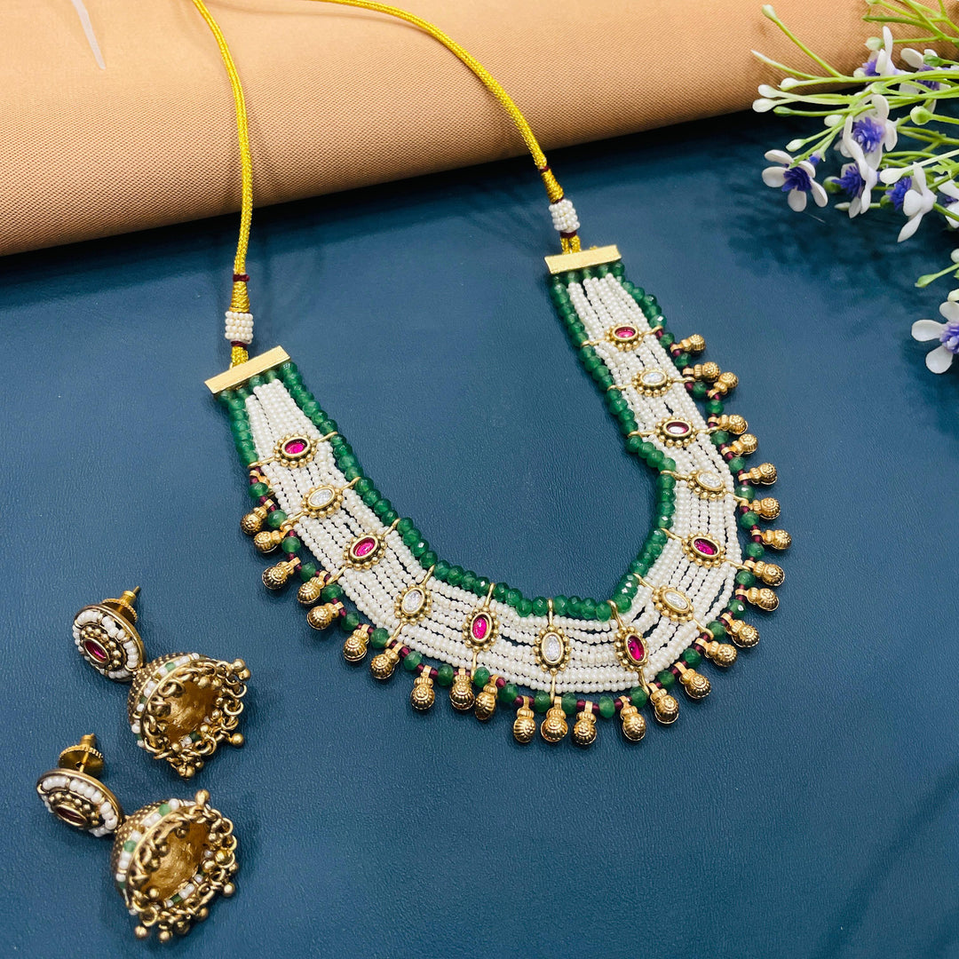 Indian choker set with antique gold finish, crafted with detailed metalwork for cultural celebrations.