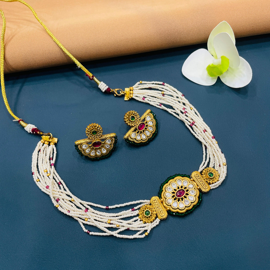 Gold-tone choker set with antique detailing, ideal for special occasions like weddings or Diwali.