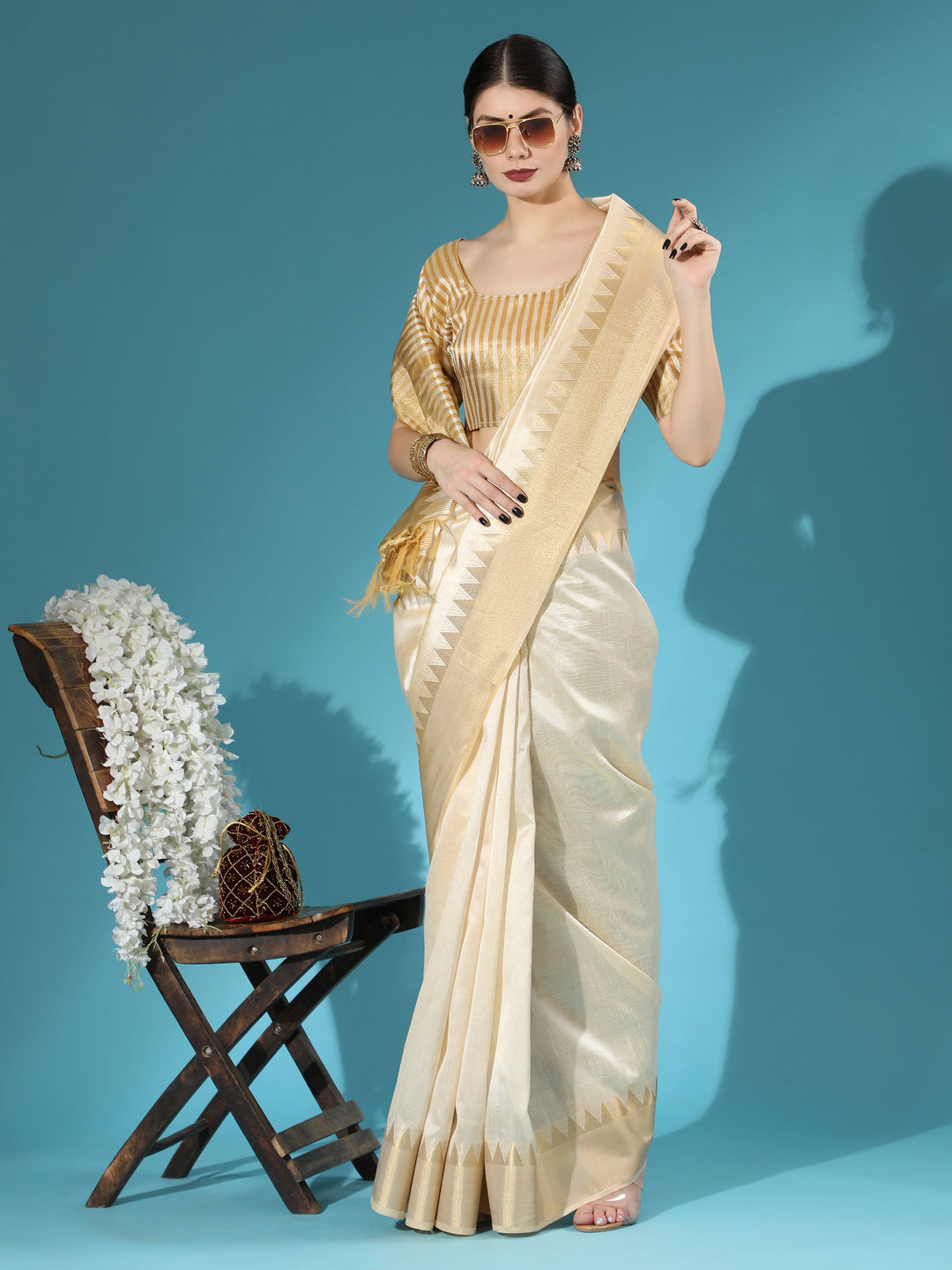 Elegant cream Indian saree with zari-woven temple border, perfect for cultural attire and festive events.