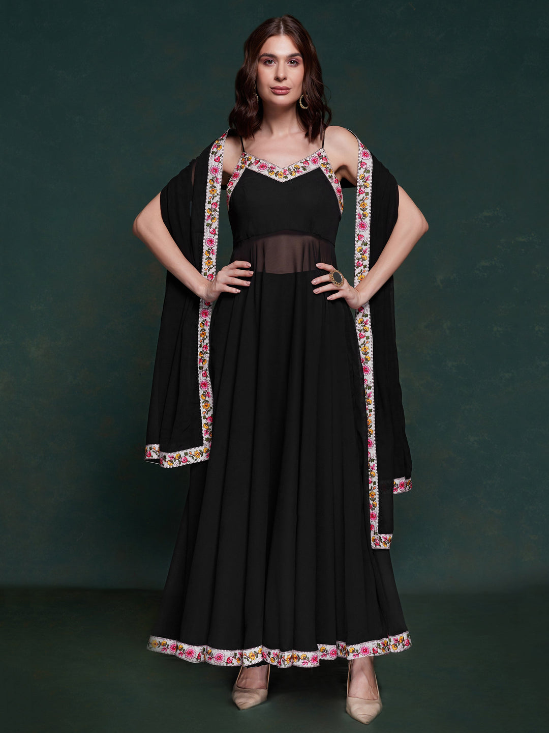 Discover elegance with this exquisite black georgette long suit, featuring intricate lacework that adds a touch of refinement.  The suit is fully stitched and available in sizes XS to XXL, offering a perfect fit and a sophisticated silhouette. Its timeless black color ensures versatility, making it a standout choice for festivals, functions, and special events. The ensemble is completed with matching black georgette pants and a dupatta, adorned with beautiful border lace work.  This coordinated design enhan