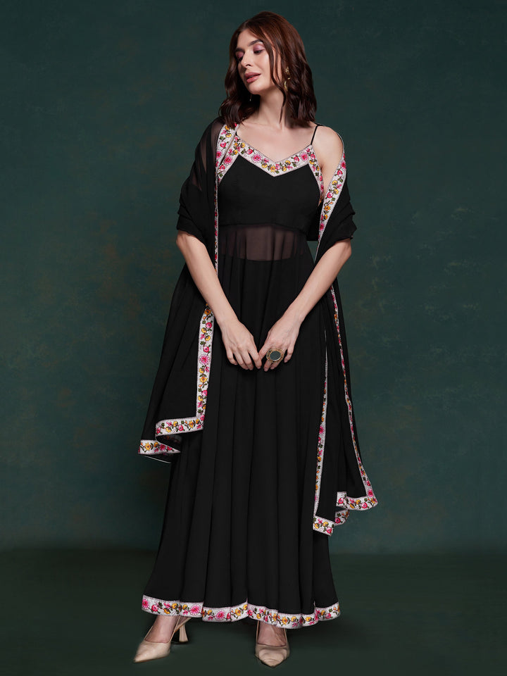 Discover elegance with this exquisite black georgette long suit, featuring intricate lacework that adds a touch of refinement.  The suit is fully stitched and available in sizes XS to XXL, offering a perfect fit and a sophisticated silhouette. Its timeless black color ensures versatility, making it a standout choice for festivals, functions, and special events. The ensemble is completed with matching black georgette pants and a dupatta, adorned with beautiful border lace work.  This coordinated design enhan