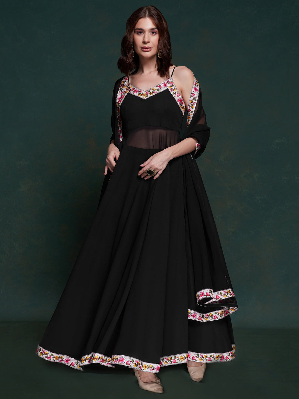 Discover elegance with this exquisite black georgette long suit, featuring intricate lacework that adds a touch of refinement.  The suit is fully stitched and available in sizes XS to XXL, offering a perfect fit and a sophisticated silhouette. Its timeless black color ensures versatility, making it a standout choice for festivals, functions, and special events. The ensemble is completed with matching black georgette pants and a dupatta, adorned with beautiful border lace work.  This coordinated design enhan