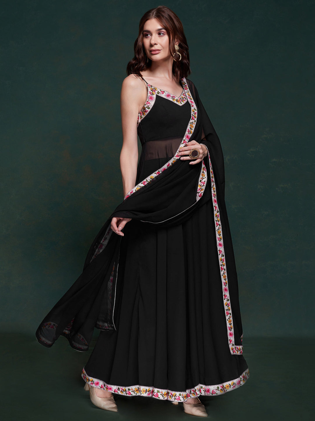 Discover elegance with this exquisite black georgette long suit, featuring intricate lacework that adds a touch of refinement.  The suit is fully stitched and available in sizes XS to XXL, offering a perfect fit and a sophisticated silhouette. Its timeless black color ensures versatility, making it a standout choice for festivals, functions, and special events. The ensemble is completed with matching black georgette pants and a dupatta, adorned with beautiful border lace work.  This coordinated design enhan